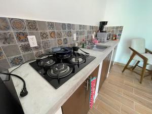 a kitchen with a stove and a counter top at Frida Kahlo in Bucerías +1 photo
