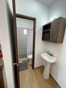 a bathroom with a toilet and a sink at Frida Kahlo in Bucerías