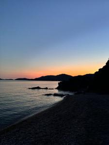 a sunset over a beach with the ocean at Ste.Mar Apartments in Teulada +12 photos