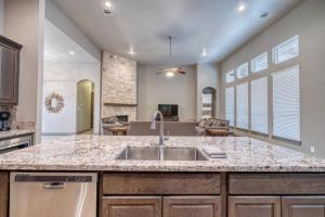 a kitchen with a sink and a living room at Driftwood in Concan +106 photos