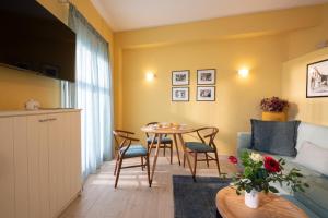 a living room with a table and a couch at Ostria Studio Kyparissia Old Town Collection in Kyparissia