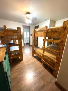two bunk beds in a room with wooden floors at Ryder's Ridge in Concan +13 photos