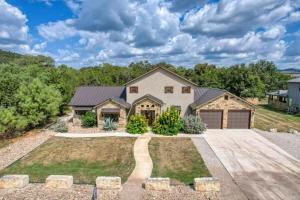 a house with a driveway and a garage at Rolling Rock in Concan