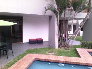 a patio with a table and chairs next to a building at Hotel Platino Expo in Guadalajara