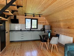 a kitchen and dining room with a table and chairs at Andezit Kazbegi in Kazbegi +15 photos