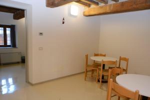 a dining room with a table and chairs at Ostello Cartiera La Buca in Colle di Val d'Elsa