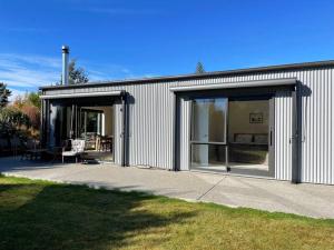 a building with sliding glass doors and a patio at Warm, sun filled apartment in Albert Town