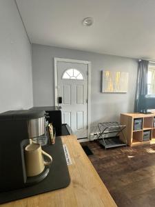a living room with a table and a door at ZenOasis pvt BedBath Studio by NUMC in East Meadow +19 photos