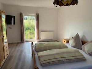 a bedroom with two beds and a window at Ferienwohnung Rheintal in Lahnstein