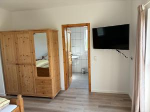 a room with a large wooden cabinet and a television at Ferienwohnung Rheintal in Lahnstein