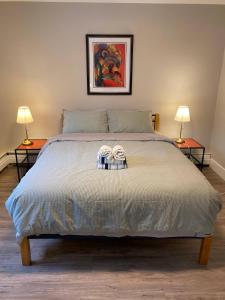 a bedroom with a bed with two towels on it at Brand New Modern Flat 2br1ba Whyte And University in Edmonton