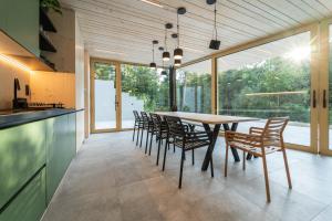 a dining room with a table and chairs at Pine chalet in Smižany