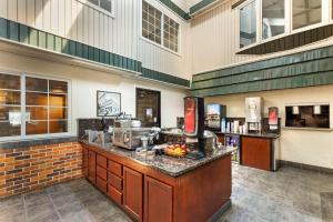 a lobby of a hotel with a counter with food at Best Western Plus Longbranch Hotel & Convention Center in Cedar Rapids