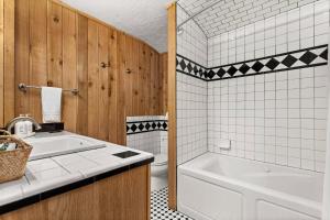 a bathroom with a tub and a toilet and a sink at #17 The Texas House at Garrison in Gruene in New Braunfels +21 photos