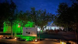 a park at night with green lighting and a picnic table at Apt 6 - High Plains Lodge at Nomad Landing in Clayton