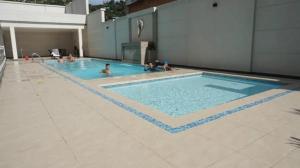 a group of people in a swimming pool at Silver park towers in Cúcuta
