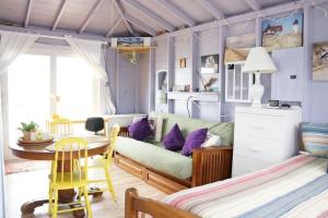 a living room with a couch and a table at Peaceful Waterfront Beach Cottage! in Truro