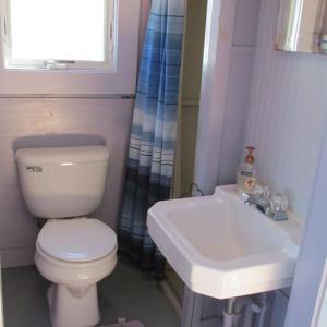 a bathroom with a toilet and a sink at Peaceful Waterfront Beach Cottage! in Truro