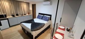 a bedroom with a bed with blue pillows on it at Flat Maravilhoso na Praia de Cabo Branco in João Pessoa