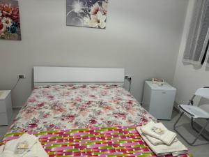 a bedroom with a bed with a floral bedspread at Casa Iris in Castellabate +29 photos