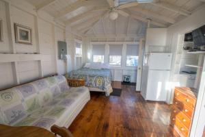 a bedroom with a bed and a couch in a room at Cozy Beach Bungalow in Truro