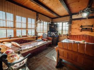 a bedroom with a large bed in a room with wooden walls at Kuća Luna in Gornji Milanovac