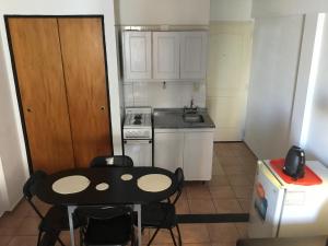 a small kitchen with a table and chairs in it at Terraza y sol in Buenos Aires