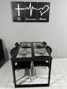 a black table with four chairs and a chalk board at No coração do Recife in Recife +21 photos