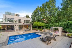 a home with a swimming pool and a house at Majestic Poolside Villa with Jacuzzi, Pool, Panoramic Views in Brunn am Gebirge