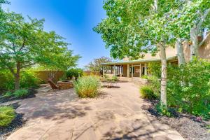 a patio in front of a house with trees at Mtn-View Retreat with Hot Tub in New Mexico! in Arroyo Seco