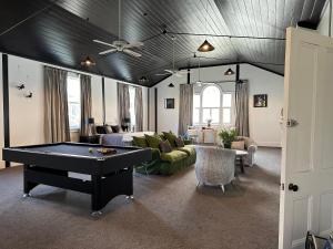 a living room with a ping pong table in it at Te Aroha courthouse in Te Aroha
