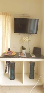 a white desk with a tv on top of it at Pittmans Sunrise in Titikaweka +3 photos