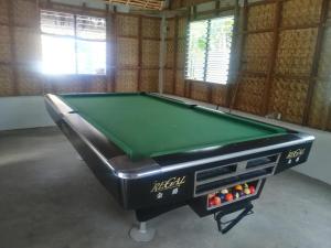 a pool table in a room with afits at Sevens Hideaway Beach Resort in Siaton