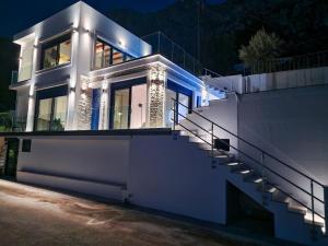 a white house with stairs in front at night at Regina - Luxury Apartments in Kalymnos