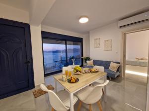a kitchen and living room with a table and chairs at Regina - Luxury Apartments in Kalymnos