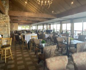 a restaurant with tables and chairs in a room at Modern Waterfront Gem with Breathtaking water views in Montgomery