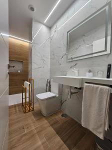 a white bathroom with a sink and a toilet at Rest Pedrouzo in O Pedrouzo