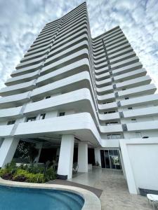 a large building with a pool in front of it at Equipetrol Depto 1 Dorm piso 12 in Santa Cruz de la Sierra