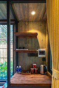 a kitchen with a counter with some bottles of water at Nomia Garden Retreats - Khu nghỉ dưỡng hồ Trị An in Xóm Ðốt Ðó +47 photos