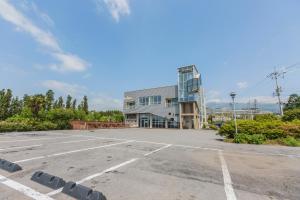 an empty parking lot in front of a building at La Comma Pension in Seogwipo