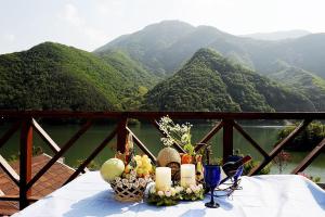 a table with fruits and candles on it with a view of mountains at Moojoo Jeonmangdae Pension in Muju