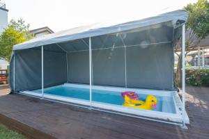 a gazebo with a rubber duck in a swimming pool at Daebudo polaris pension in Ansan