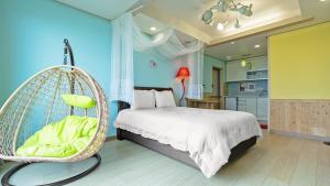 a bedroom with a bed and a swing at Namhae Healing Time Pension in Namhae +11 photos
