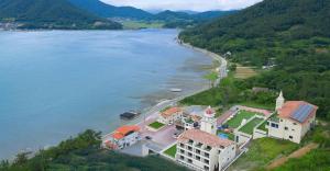 an aerial view of a house next to a body of water at Yeosu Musical House in Yeosu