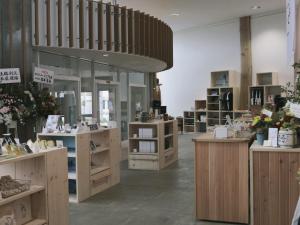 a store with wooden counters and flowers on display at Okhotsk House Shari in Shari