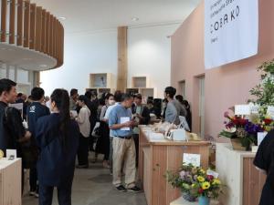 a group of people standing in a room with a crowd at Okhotsk House Shari in Shari