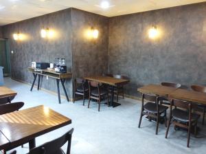 a dining room with wooden tables and chairs at Prince Hotel in Goseong