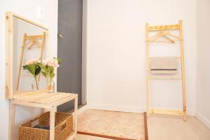 a room with a mirror and a vase with flowers at Sweet Pension Yangyang in Yangyang