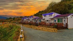 a row of houses on the side of a road at Jeonnam Cheongsando Yeohaeng Pension in Wando +35 photos