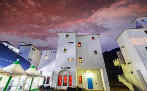 a large white building with red doors and windows at Chuncheon Pier Star Pension in Chuncheon